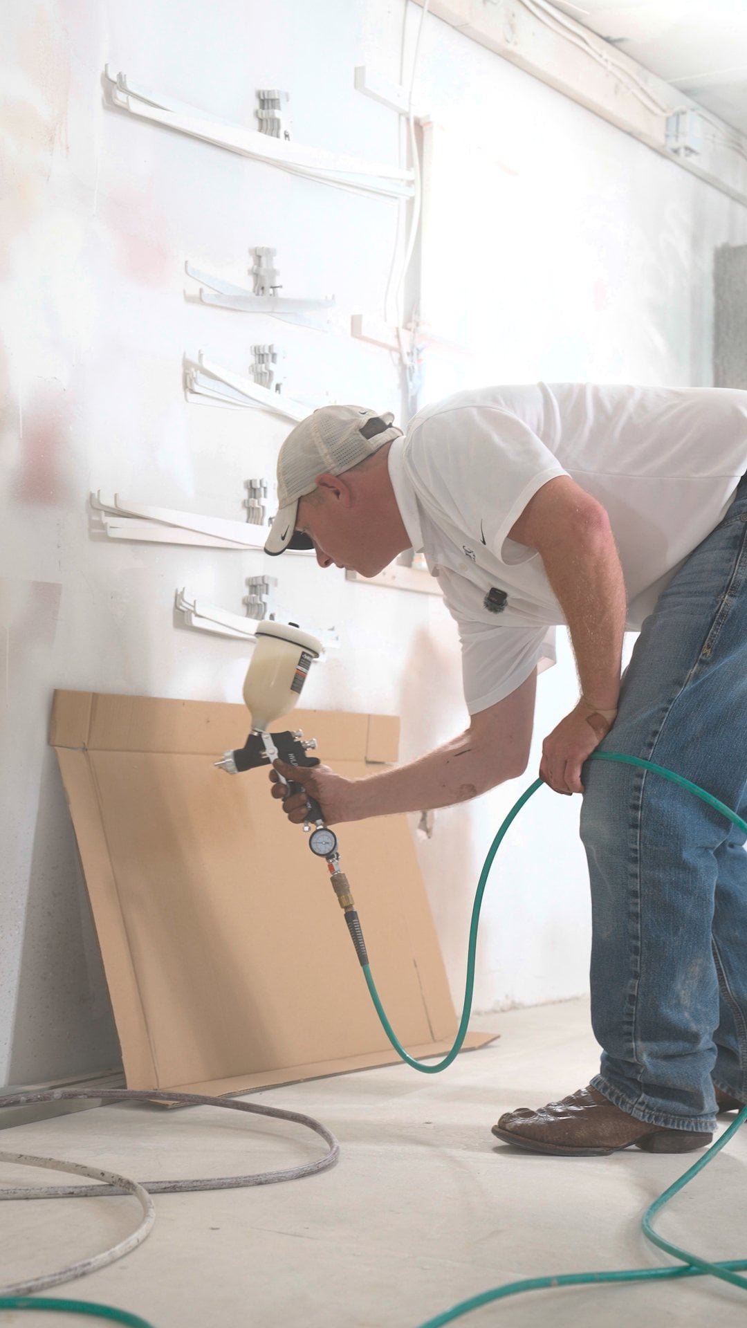 Dialing in the spray pattern on cardboard before spraying cabinet parts