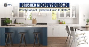 White kitchen with a navy island and cabinet pulls illustrating brushed nickel versus chrome