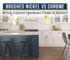 White kitchen with a navy island and cabinet pulls illustrating brushed nickel versus chrome